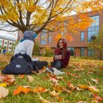 Sitting and talking on a fall day outside at the Student Union Mall with leaves on the ground on Oct. 22, 2015. (FJ Gaylor/UConn Photo) (FJ Gaylor/UConn Photo)